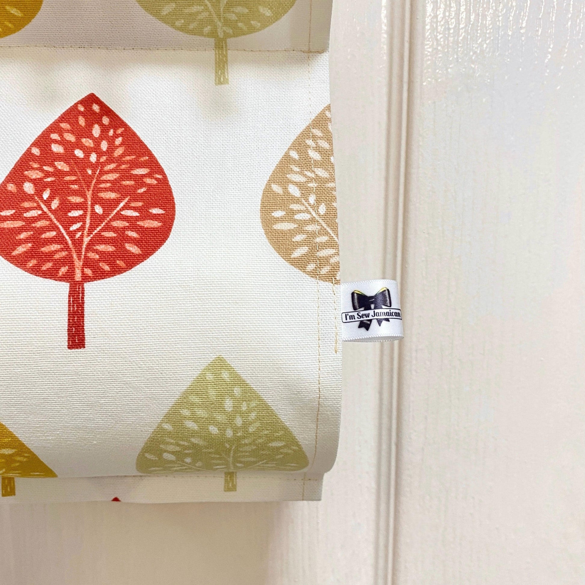 Close up earthy-coloured cotton fabric toilet roll holder in a bathroom.