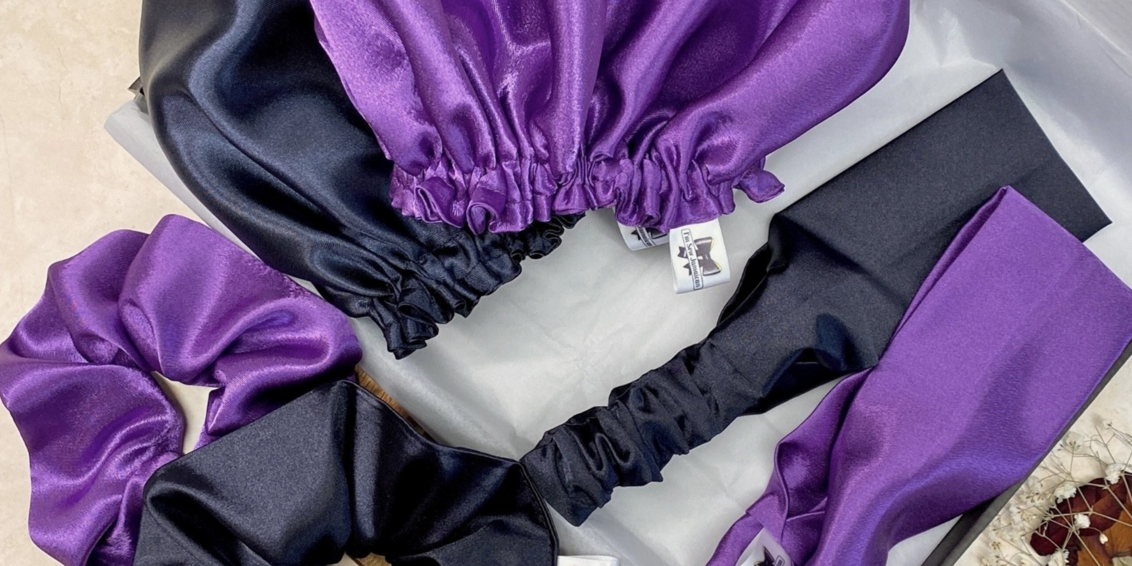 Navy blue and purple satin bonnet gift set with matching scrunchies and headbands, packaged in eco-friendly small business gift box