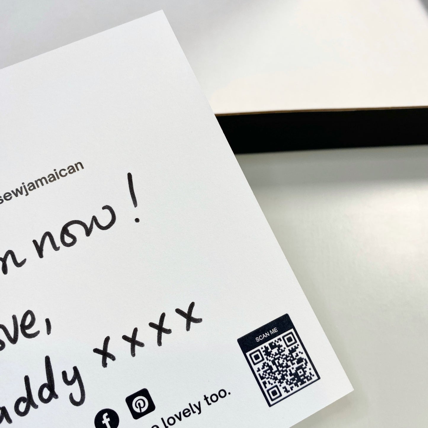 White card with black text and a QR code on a light gray background