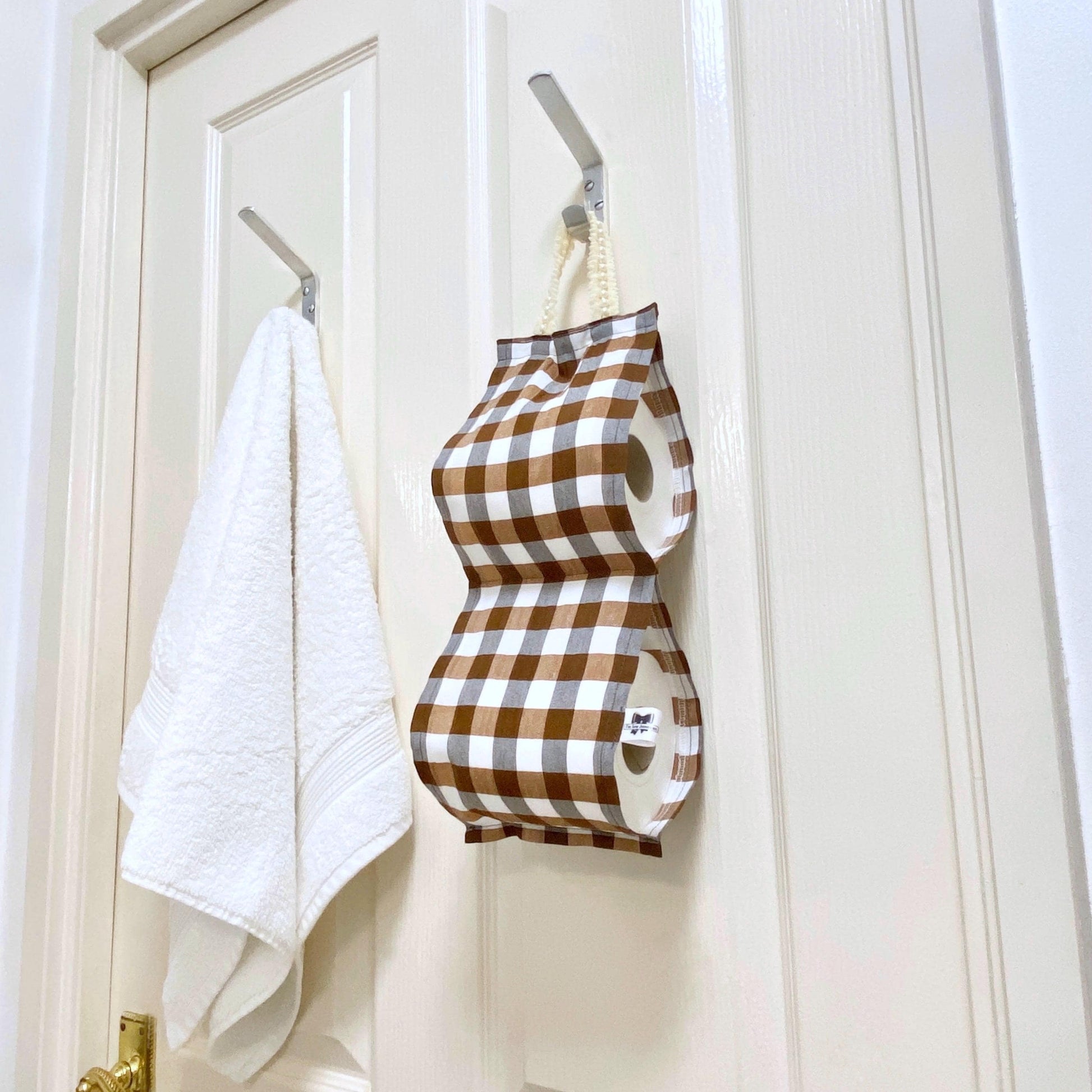 Brown gingham fabric toilet roll holder hanging bathroom.