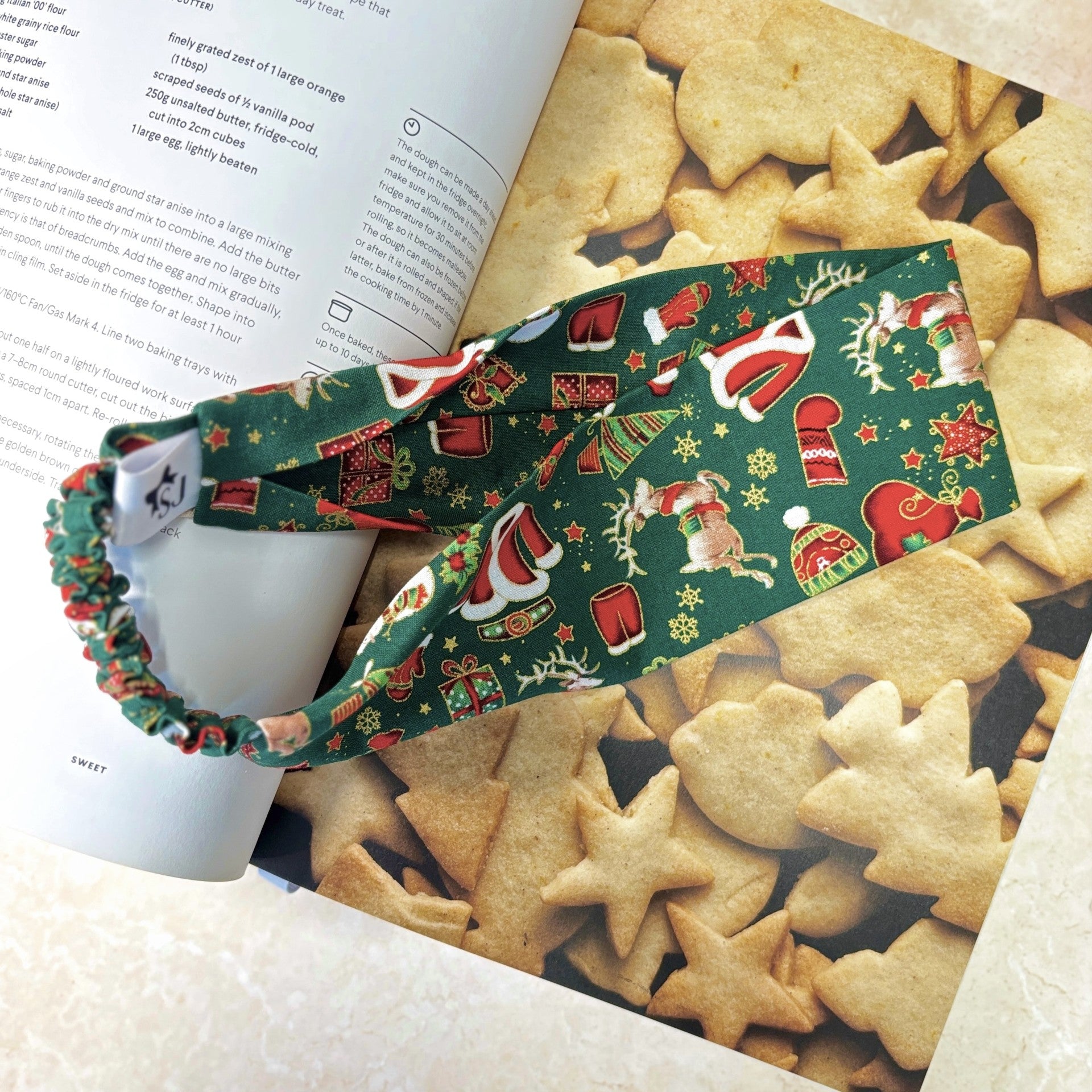 Green Christmas headband on a book with star-shaped cookies