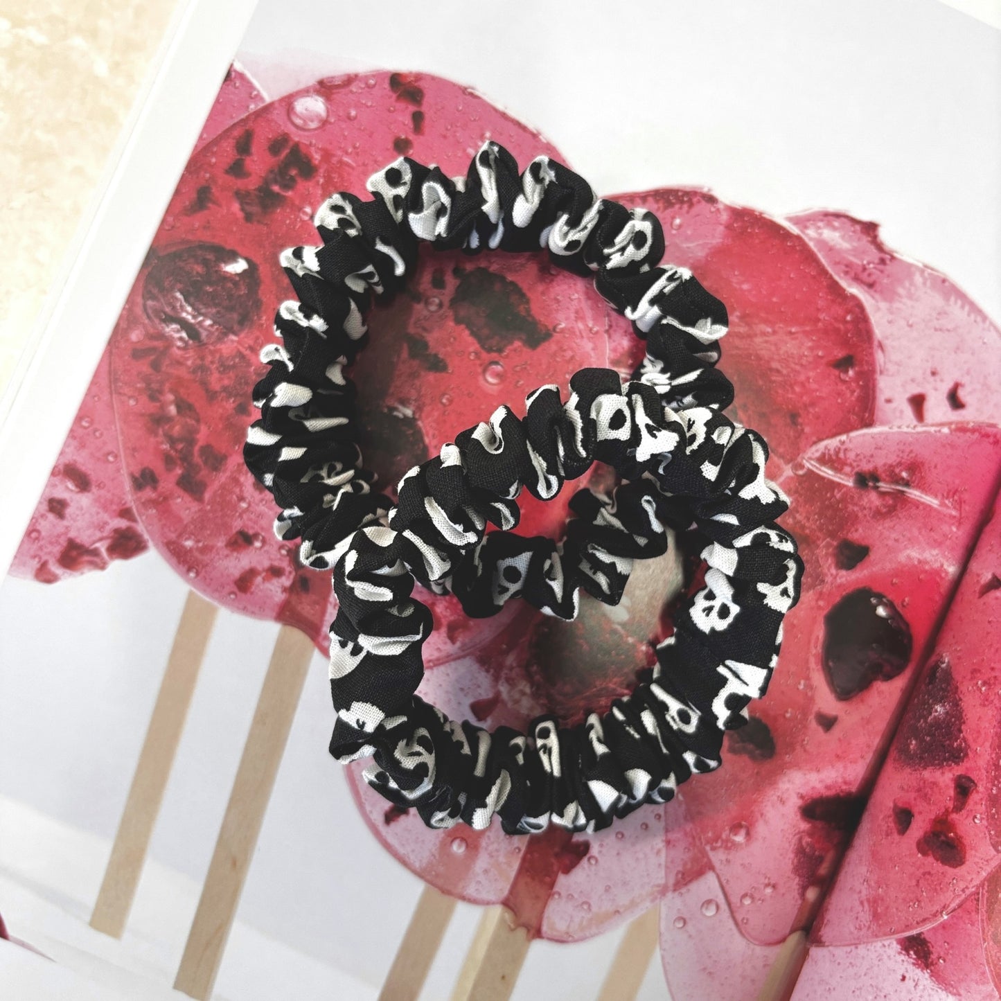 Black and white patterned scrunchies on a book background