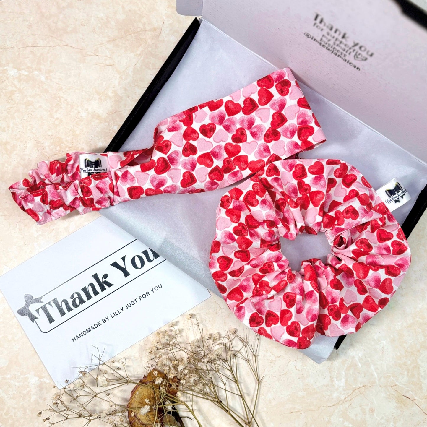 Cotton heart print pink and red headband and scrunchie in packaging box on white tissue paper with props, thank you card perfect for hair styling, fashion accessories, and gifting, from a small business.