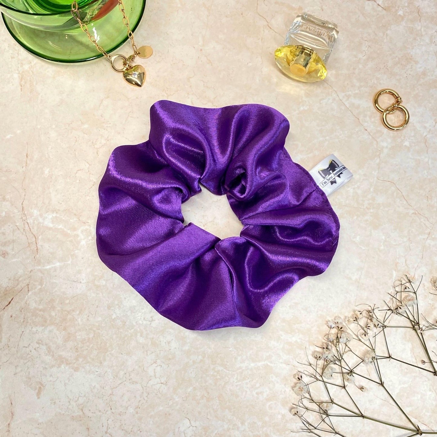 Navy blue satin hair scrunchie with shine, stylish accessory for all hair types.