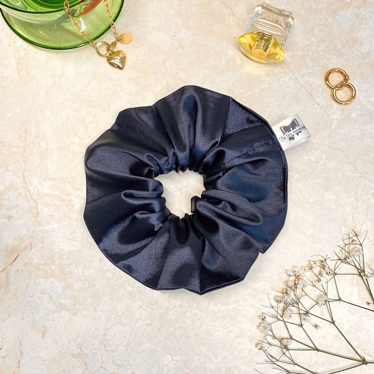 Navy blue satin hair scrunchie with shine, stylish accessory for all hair types.