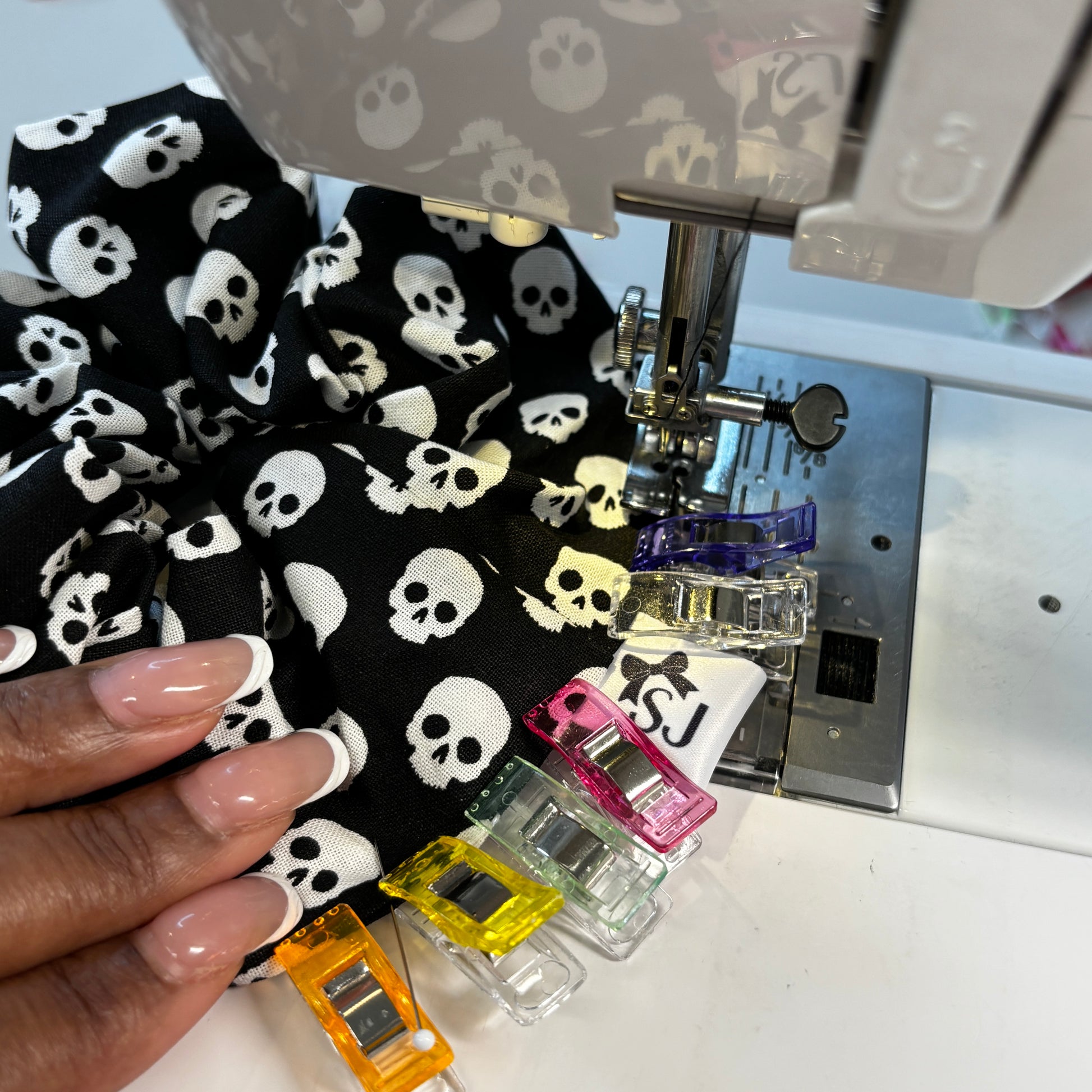 Skull-patterned fabric being sewn on a sewing machine 