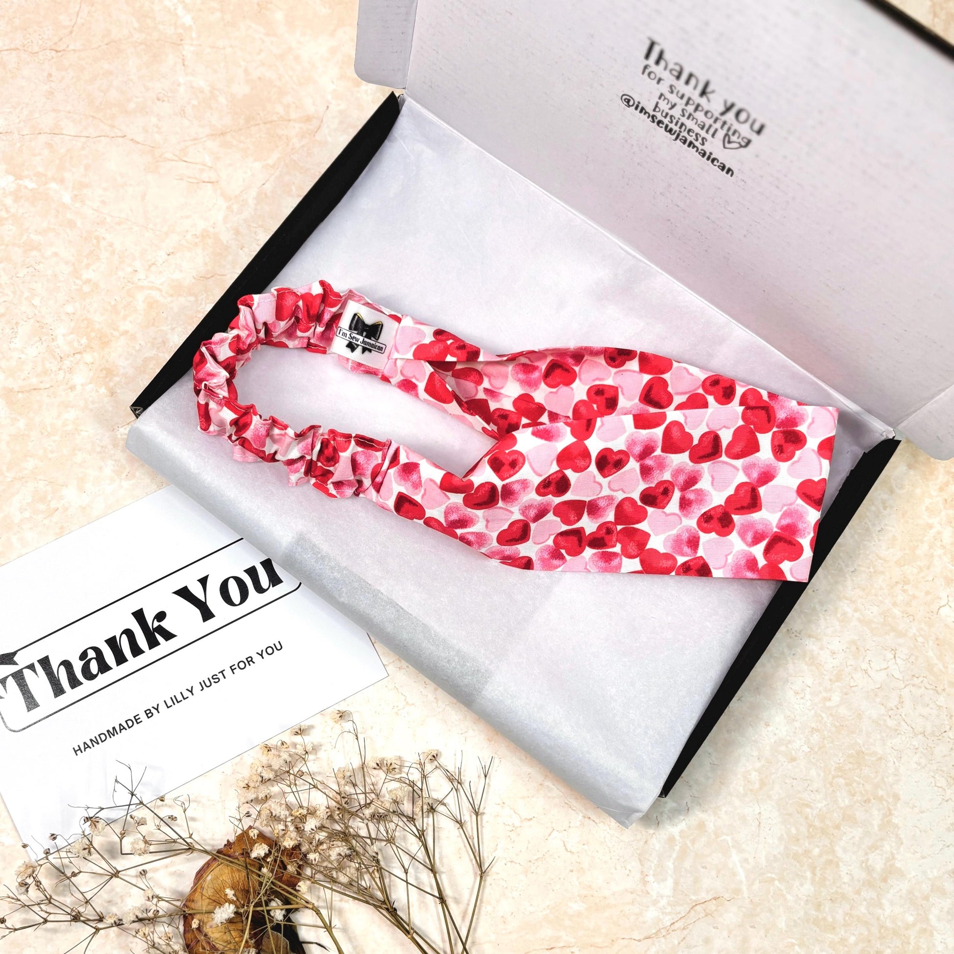 Cotton heart print pink and red headband in packaging box on white tissue paper with props, and thank you card perfect for hair styling, fashion accessories, and gifting, from a small business.