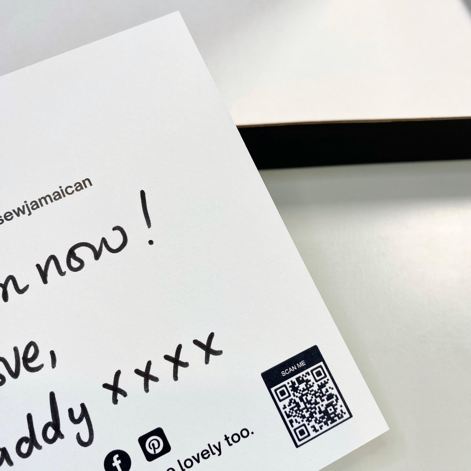 A handwritten thank you card with a personalised gift message, held in hand, for small business customer orders.