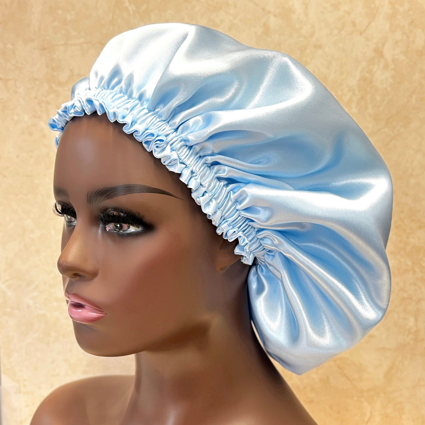 Baby blue satin hair bonnet on mannequin head