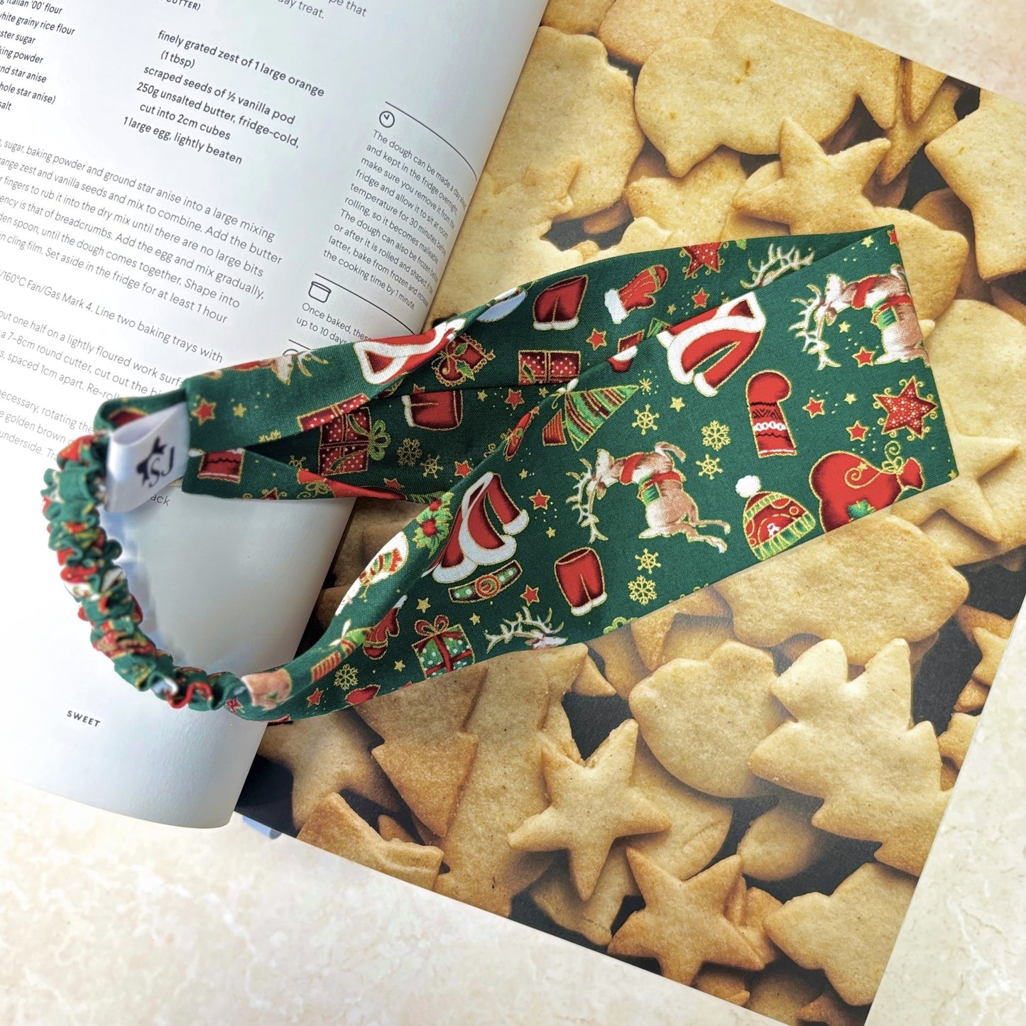 Green Christmas headband on a book with star-shaped cookies