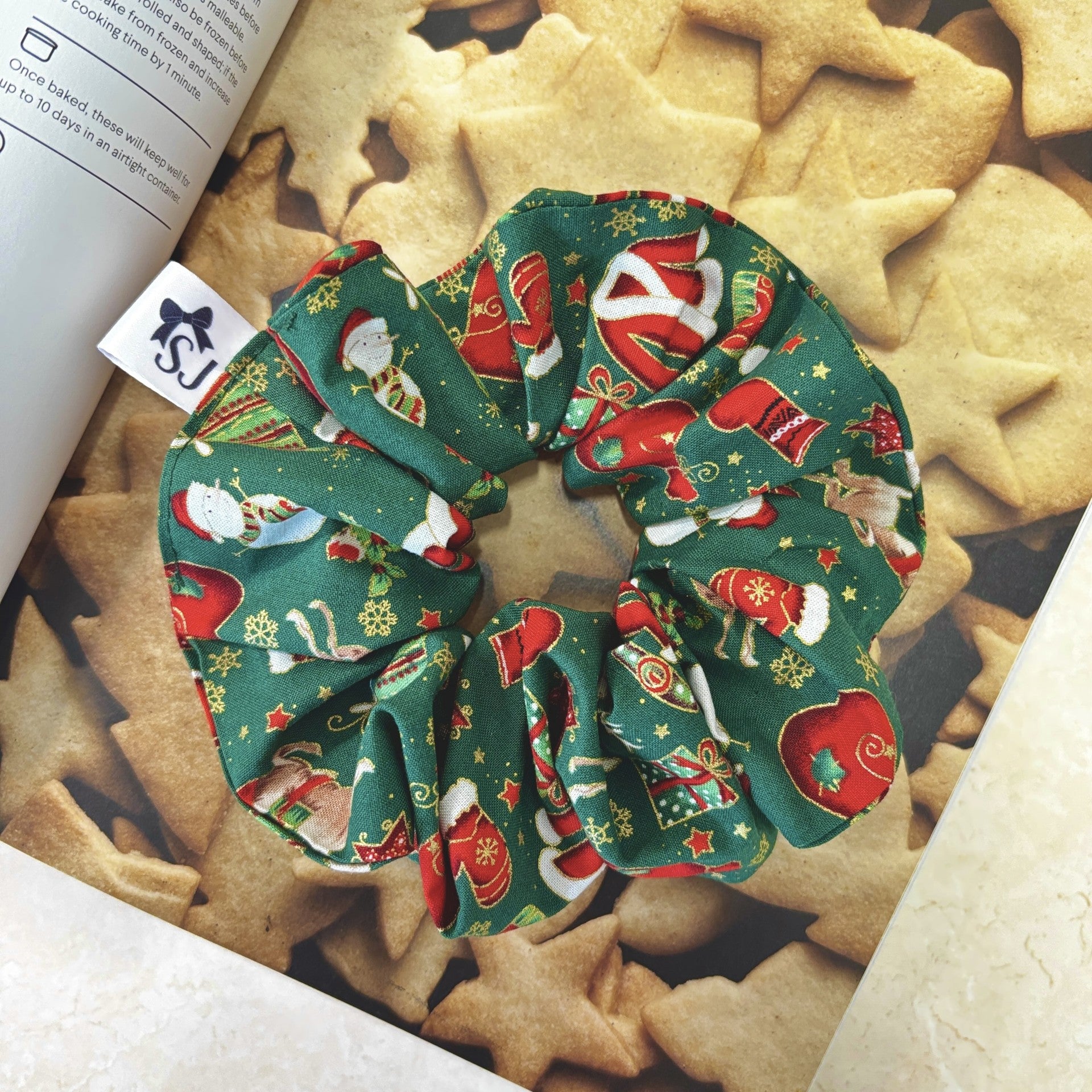 Christmas scrunchie on a pile of star-shaped cookie book