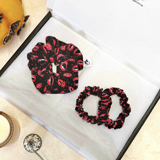 Set of black Halloween scrunchie with red lip print on a scrunchies with red lip prints on a white box.
