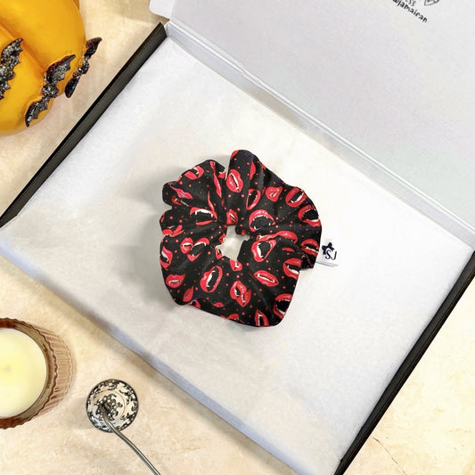 Black Halloween scrunchie with red lip pattern on a white box