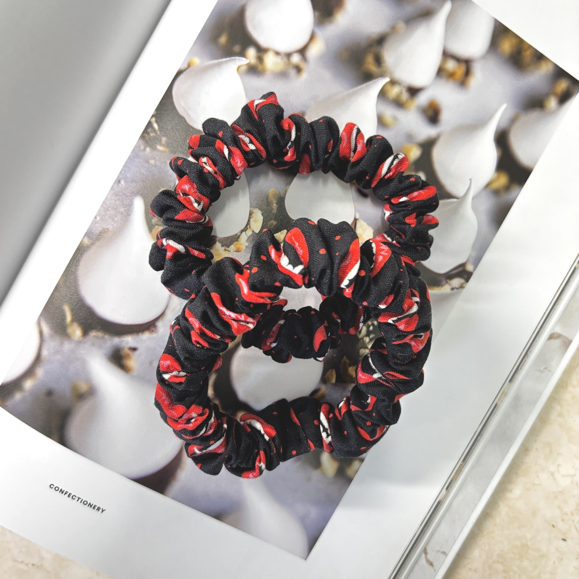 Halloween Black and red scrunchie on a magazine with blurred background