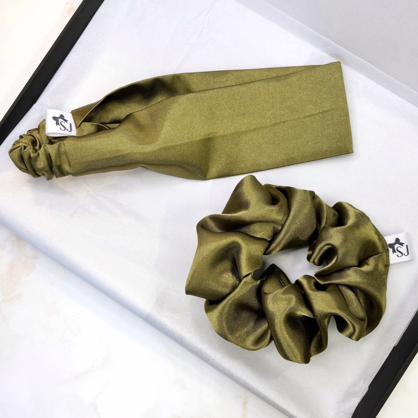 Green satin headband and scrunchie on a white background