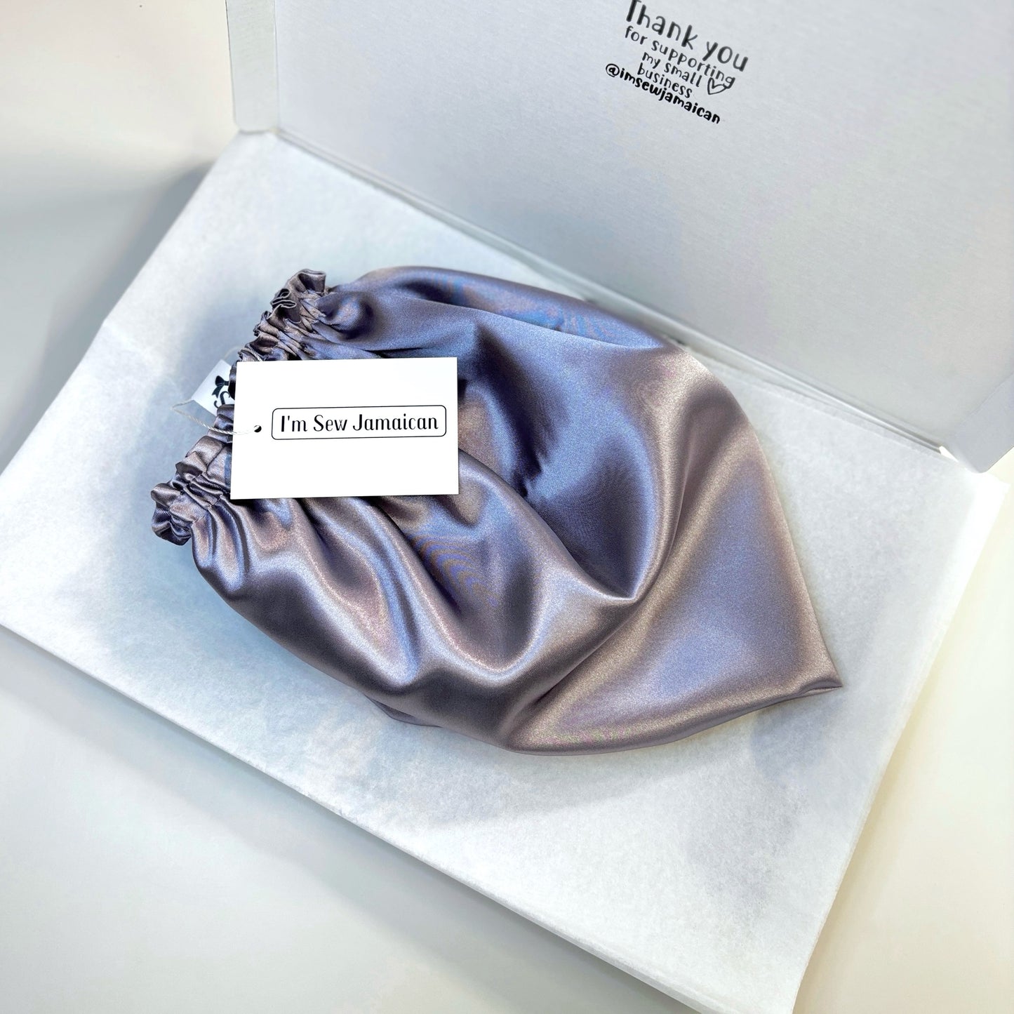 Lilac satin bonnet in packaging shipping box