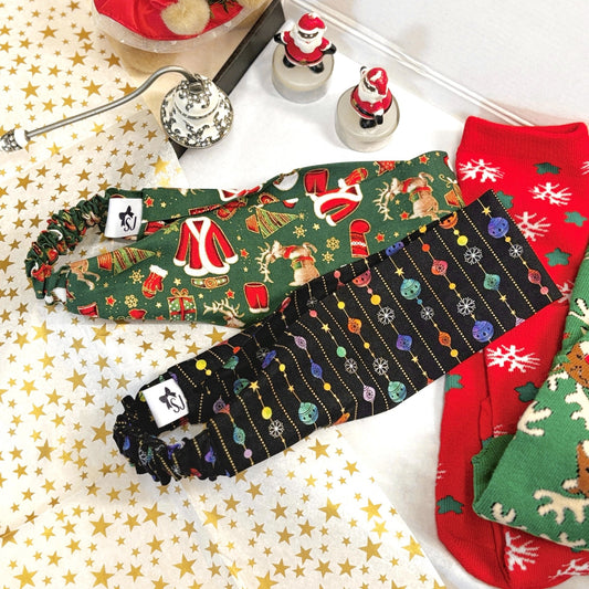 Set of Christmas-themed hairbands and socks in gift box with with gold star tissue paper.