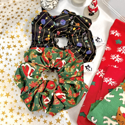 Set of Christmas scrunchies and socks in gift box with with gold star tissue paper.